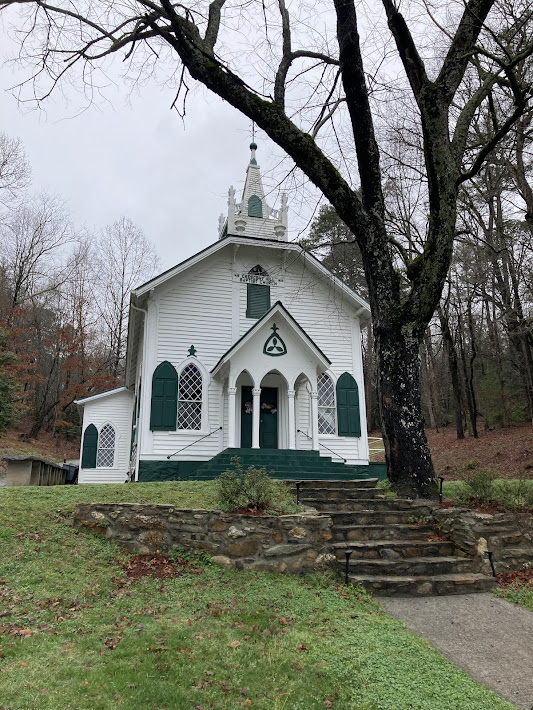 View of historic white and green church.